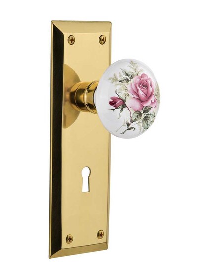 New York Plate with Rose Porcelain Knob with Keyhole in Polished Brass.